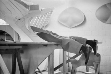 Eero Saarinen climbing inside model of TWA Flight Center